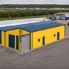 Aerial view of a yellow and navy commercial shed within a business-park setting.