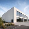 White prefabricated office building with full-height glazing and flat panel cladding, built by SAMAN.