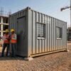 SAMAN 20-ft container office cabin exterior — corrugated Corten steel, aluminium windows with MS grills, Indian construction site