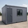 Steel grey container building unit, 20×15 ft, MS-clad single-storey commercial structure on level ground.