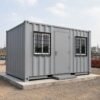 Front view of a SAMAN container portable office showing steel entry door, MS-grill windows, access step, and RCC platform foundation