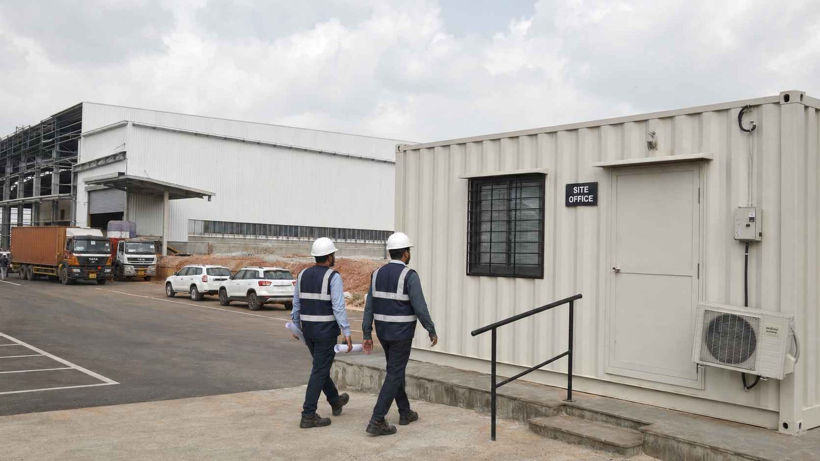 A SAMAN container portable office configured as a settled corporate site office at an Indian industrial warehouse project nearing completion