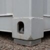 Close-up of corner casting and twist-lock fitting on a container site office at the base.