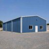 Steel-blue engineered steel building, 2,100 sq ft, complete on a cleared industrial plot.