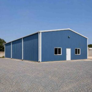 Steel-blue engineered steel building, 2,100 sq ft, complete on a cleared industrial plot.