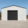 White engineered building front gable with roller shutter and personnel door.