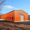 Orange engineered metal building with a roller shutter on an industrial plot