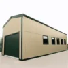 Cream PUF-panel engineered metal building with a roller shutter and a row of side windows