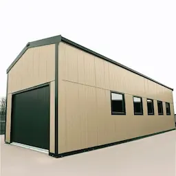 Cream PUF-panel engineered metal building with a roller shutter and a row of side windows