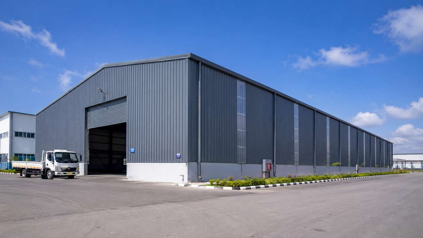Engineered metal building used as a warehouse on an Indian industrial estate