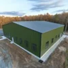 Green engineered steel building newly erected on a concrete foundation at a project site