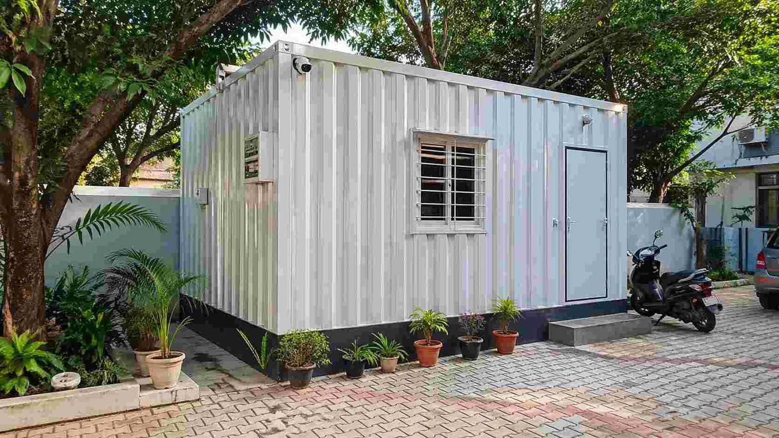 Portable cabin installed at residential premises with garden setting South India