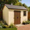 ream garden shed with brown doors and a wheelbarrow and garden tools parked outside.