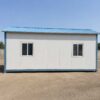 Labor cottage side profile showing PUF sandwich panel cladding, sealed vertical joints, and PPGI roof drainage slope
