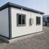Slate Charcoal hutment side wall with sliding windows, safety grilles, and exterior distribution box.