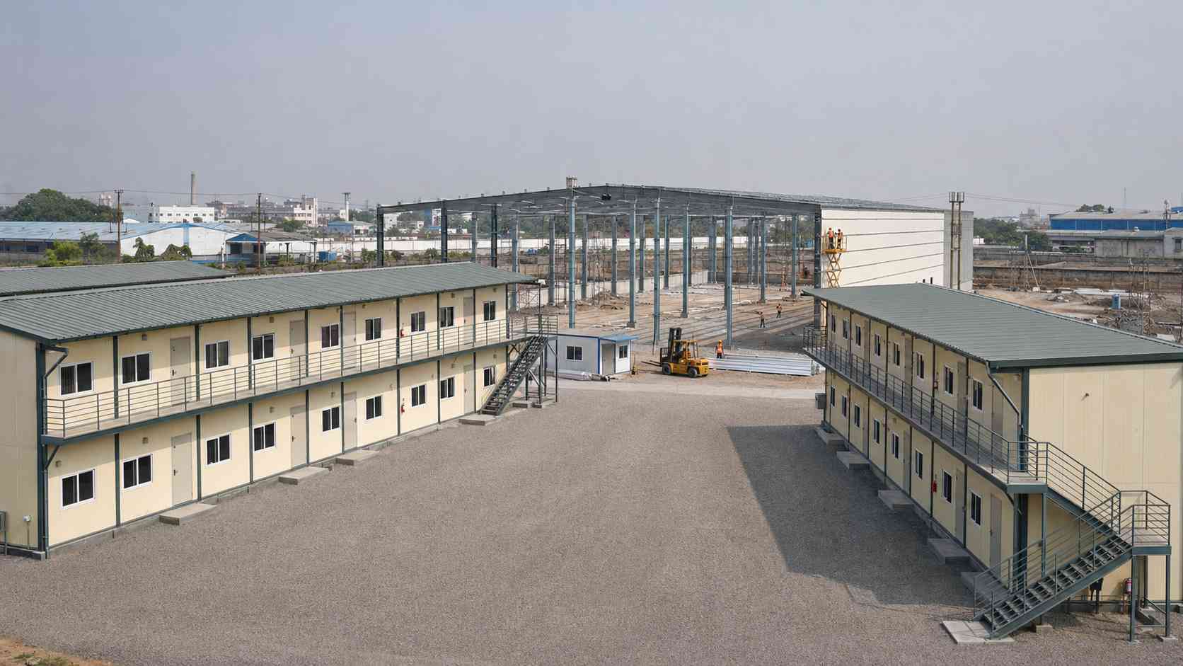 Two G+2 SAMAN labor shelter blocks at a factory-expansion warehouse construction project in India