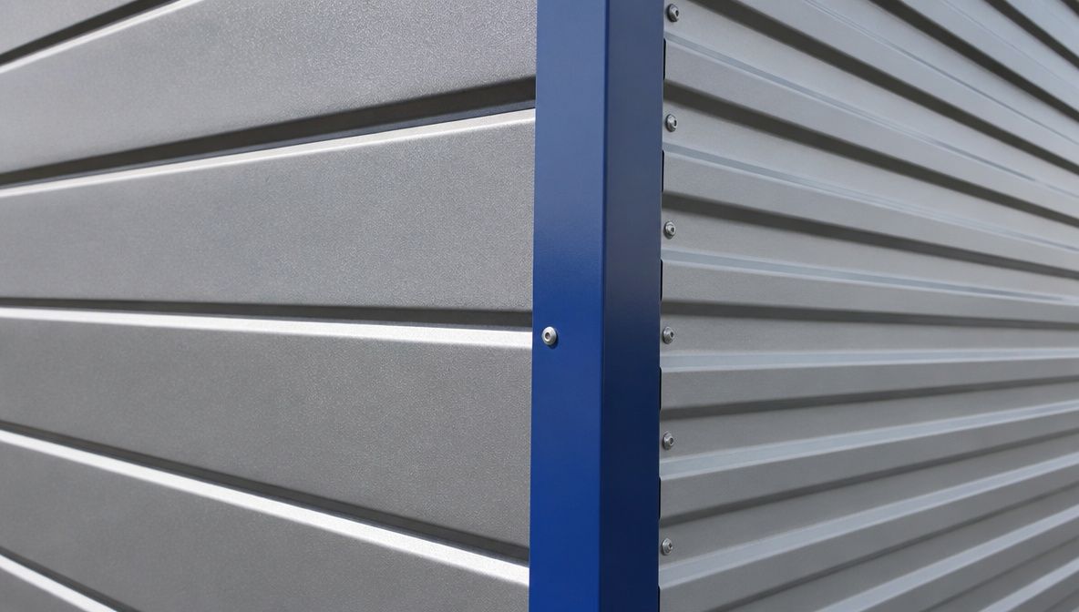 Metal building cladding detail comparing a thick PUF sandwich panel with single-skin metal sheeting