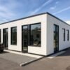 White prefab commercial building with black framed windows