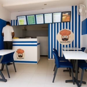 Interior of a SAMAN mobile cafe deployed at Hosur on the Bangalore circuit, with blue-and-white brand fitout, customer ordering counter and dine-in seating.