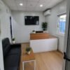 Mobile office container reception interior with desk and sofa