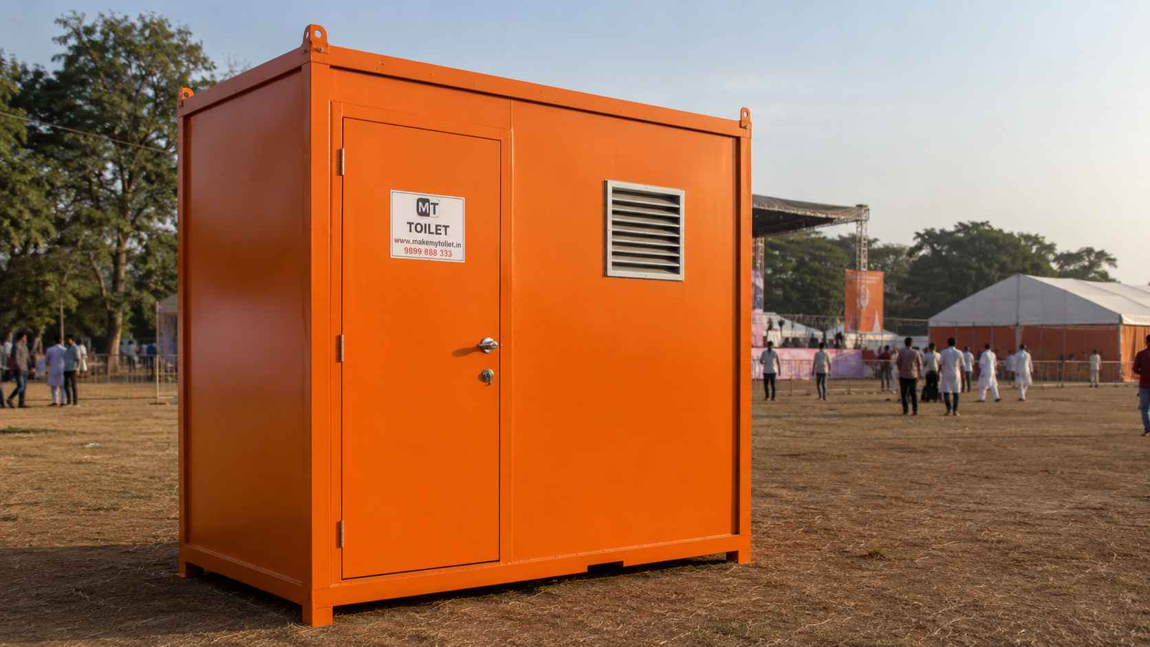 Safety orange mobile toilet cabin set up on an outdoor event ground for visitor sanitation.