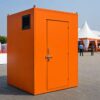Safety orange mobile toilet cabin placed at an outdoor event on level ground.