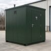 Forest green mobile toilet cabin side view showing depth, a lockable door and wall vent.