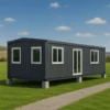 Modern cargo container house with glass windows in open field.