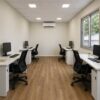 Interior of the modern office cabin showing the open studio layout with four desks and LED ceiling panels