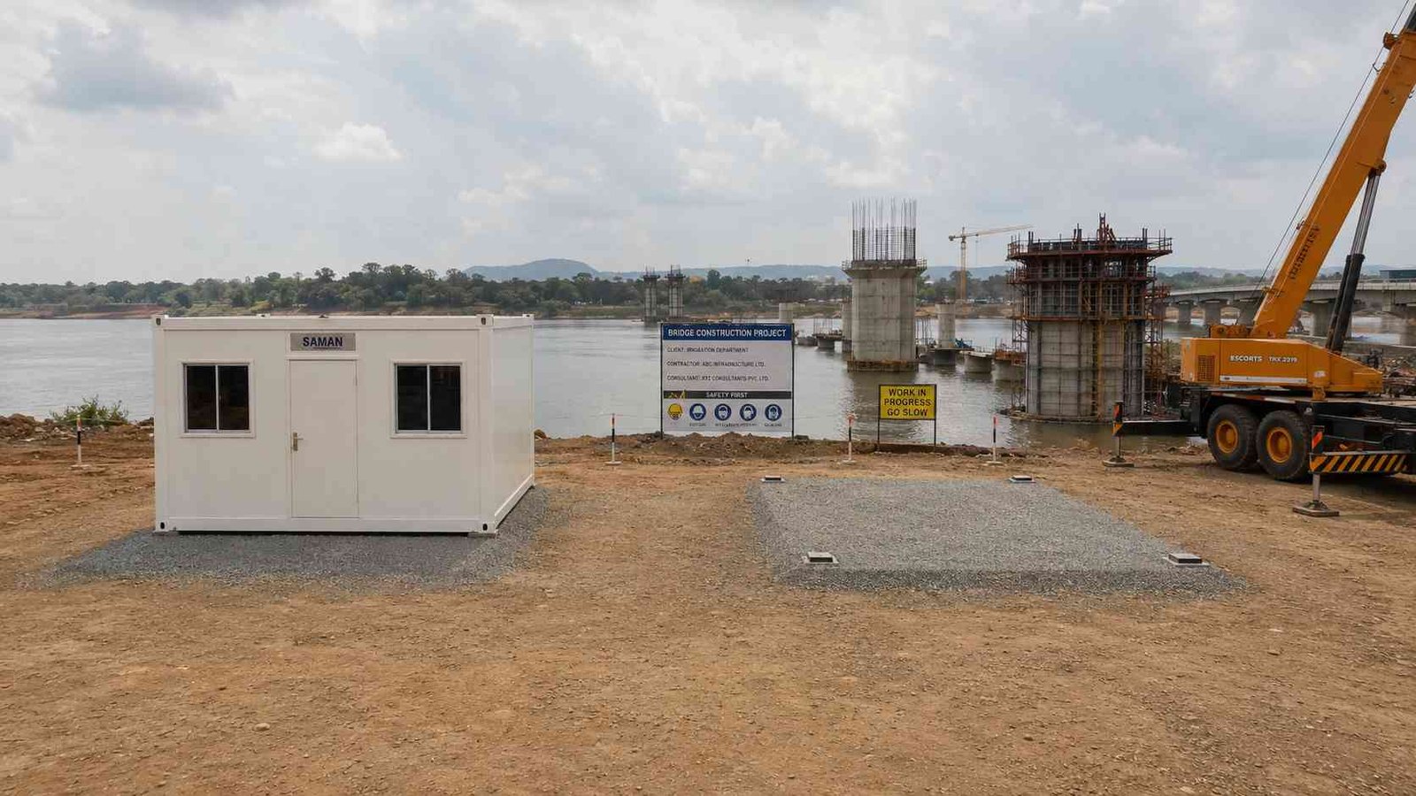 Pure White SAMAN modular container office at bridge construction site with prepared pad grid and crane re-entry corridor visible.