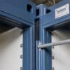 Macro close-up of Steel Blue modular container office connection junction with EPDM gasket and conduit run visible.