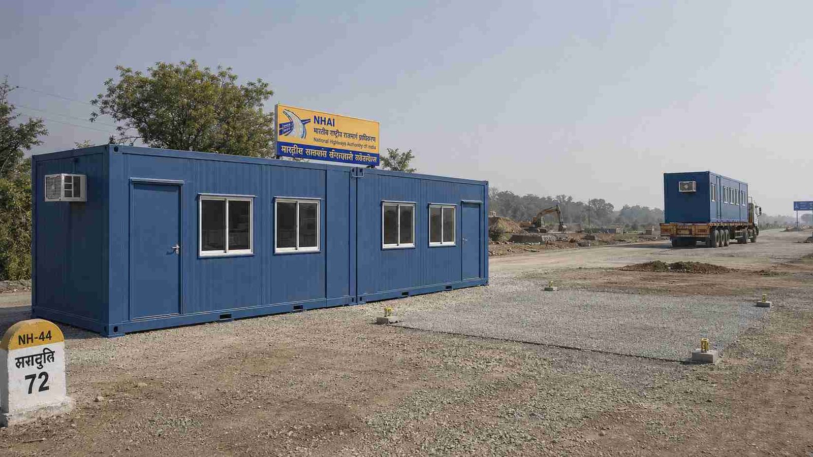 Steel Blue SAMAN modular container office at NHAI highway site with two operational units and prepared pad for next phase.