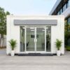 Pure White modular office building front facade with a centred glass office entrance.