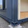 Detail of a modular office building's steel frame and Steel & Wood panel junction.