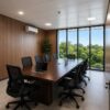 Upper floor meeting room inside modular portable office with large glass windows, conference table, and LED ceiling