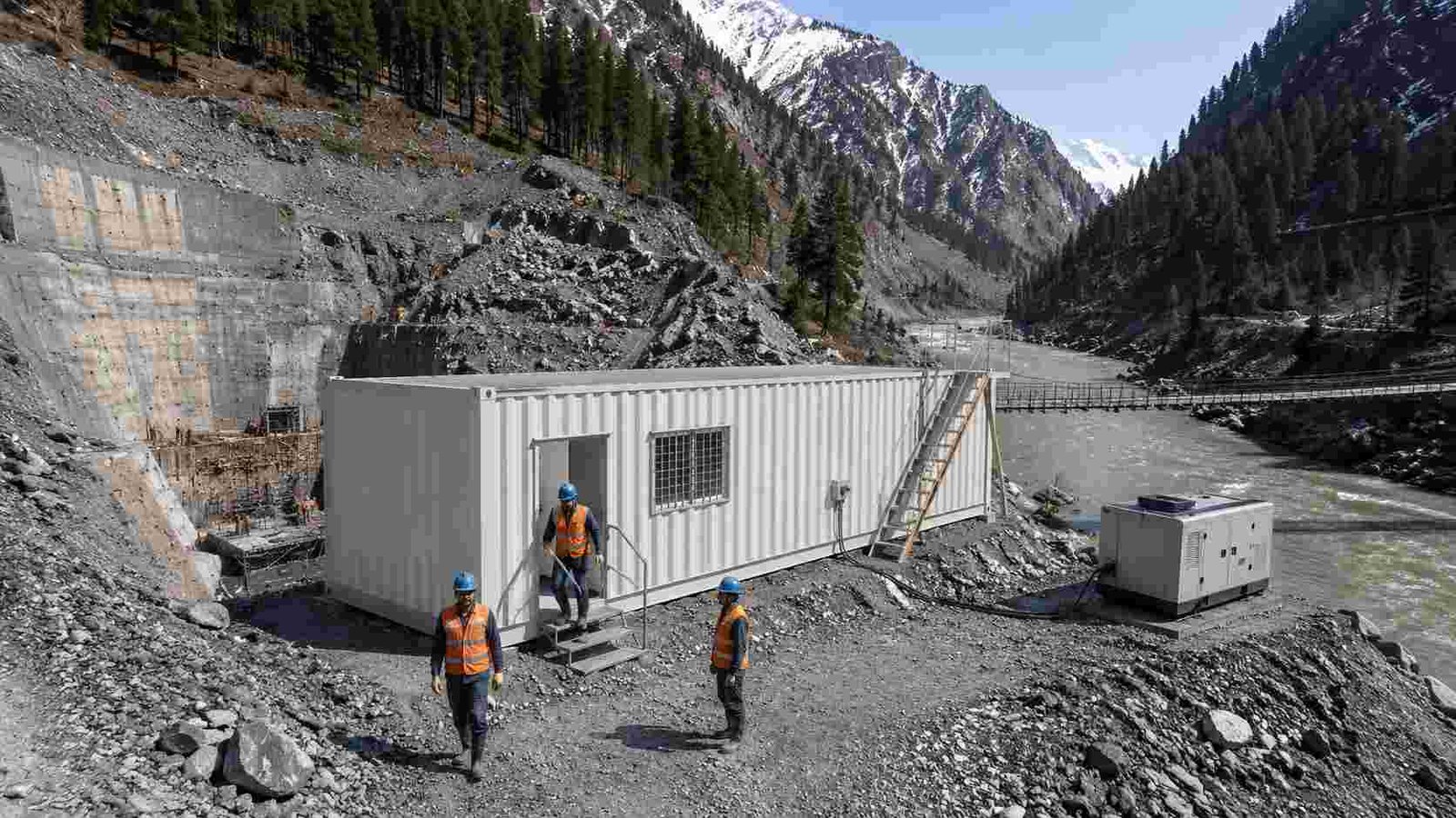 40-ft construction site office container at Himachal Pradesh hydropower project, glacial river and snow peaks behind, generator on right