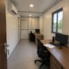 MS portable office cabin interior with false ceiling, LED lighting, vinyl flooring, and AC unit