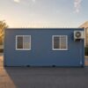 Steel Blue office cabin side elevation, sliding windows with grills, AC bracket and electrical conduit on side wall.