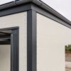 Close-up of off-white PUF sandwich panel, charcoal trim and mild steel frame on a SAMAN PEB building