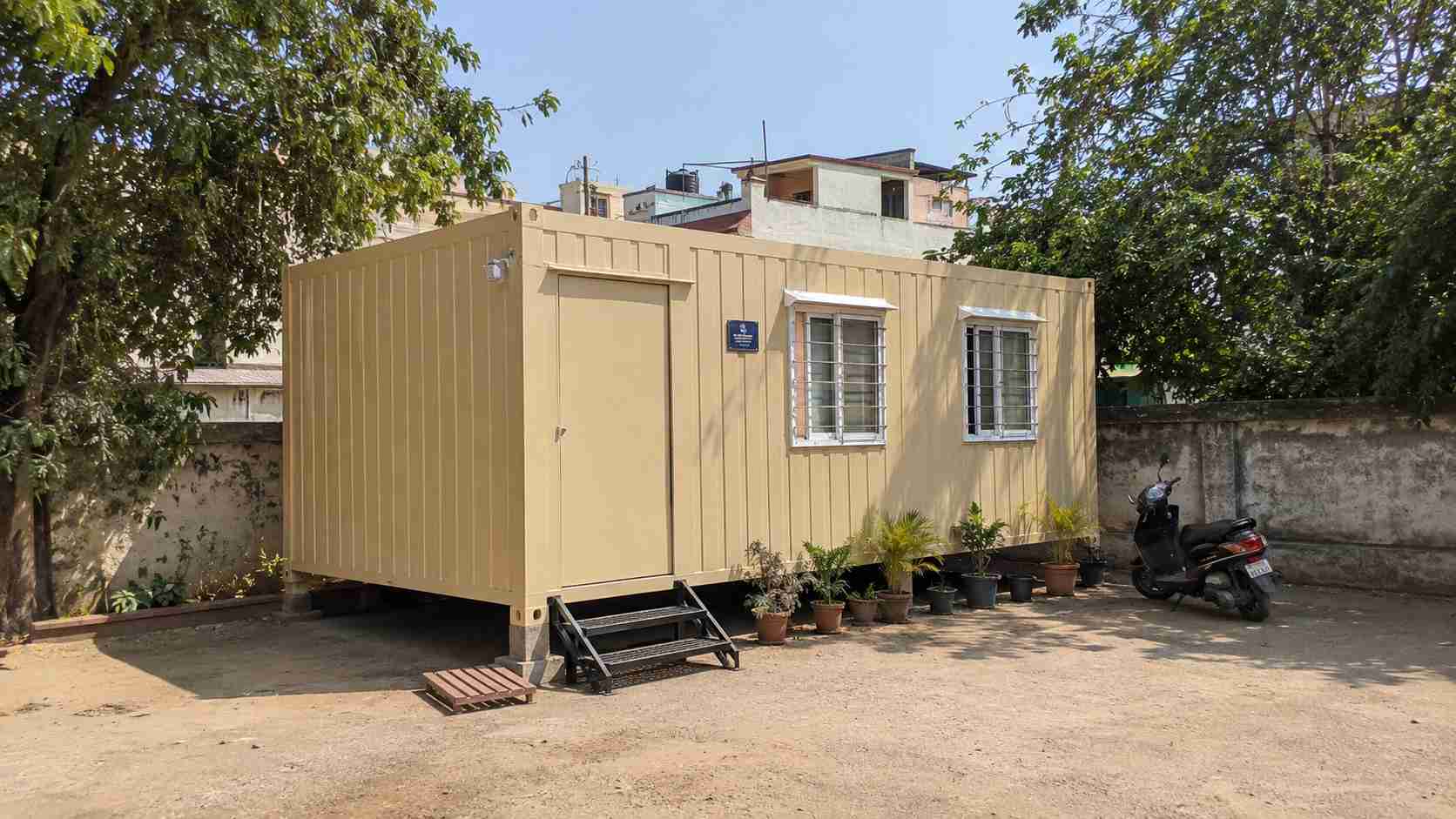 Sandstone beige porta cabin house installed as a home on a private residential plot.
