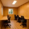 Wooden finish porta cabin interior with desks and chairs