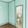 Porta cabin interior with blue walls and toilet attached