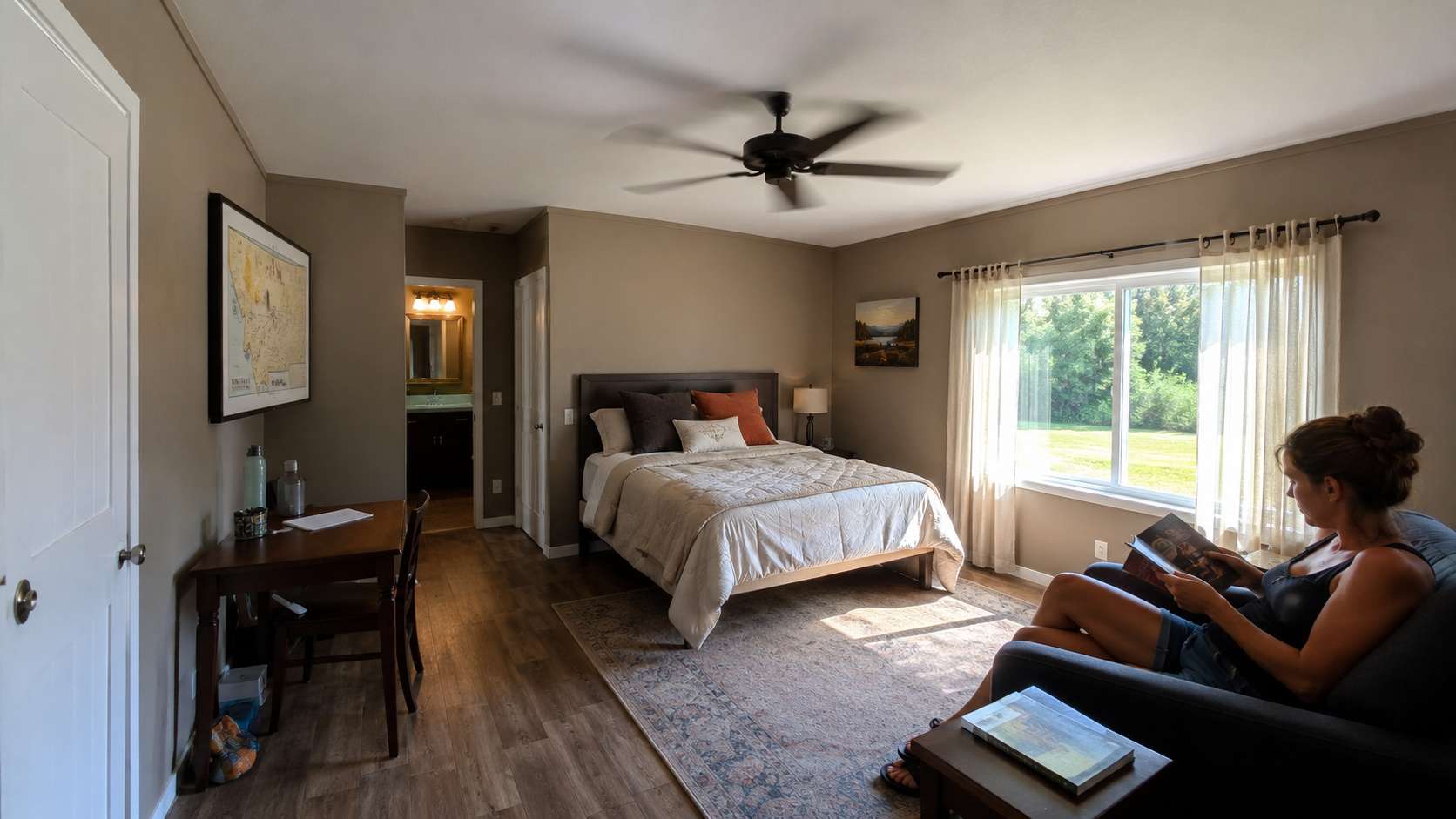 Comfortable taupe-finished cabin house interior with a fan and window on a warm day