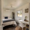 White interior of a portable cabin house set up as a livable single room