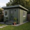 Sage green portable cabin house with door and windows on a residential plot