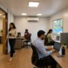 SAMAN portable office cabin interior in use — small team working inside the finished 20×10 ft cabin