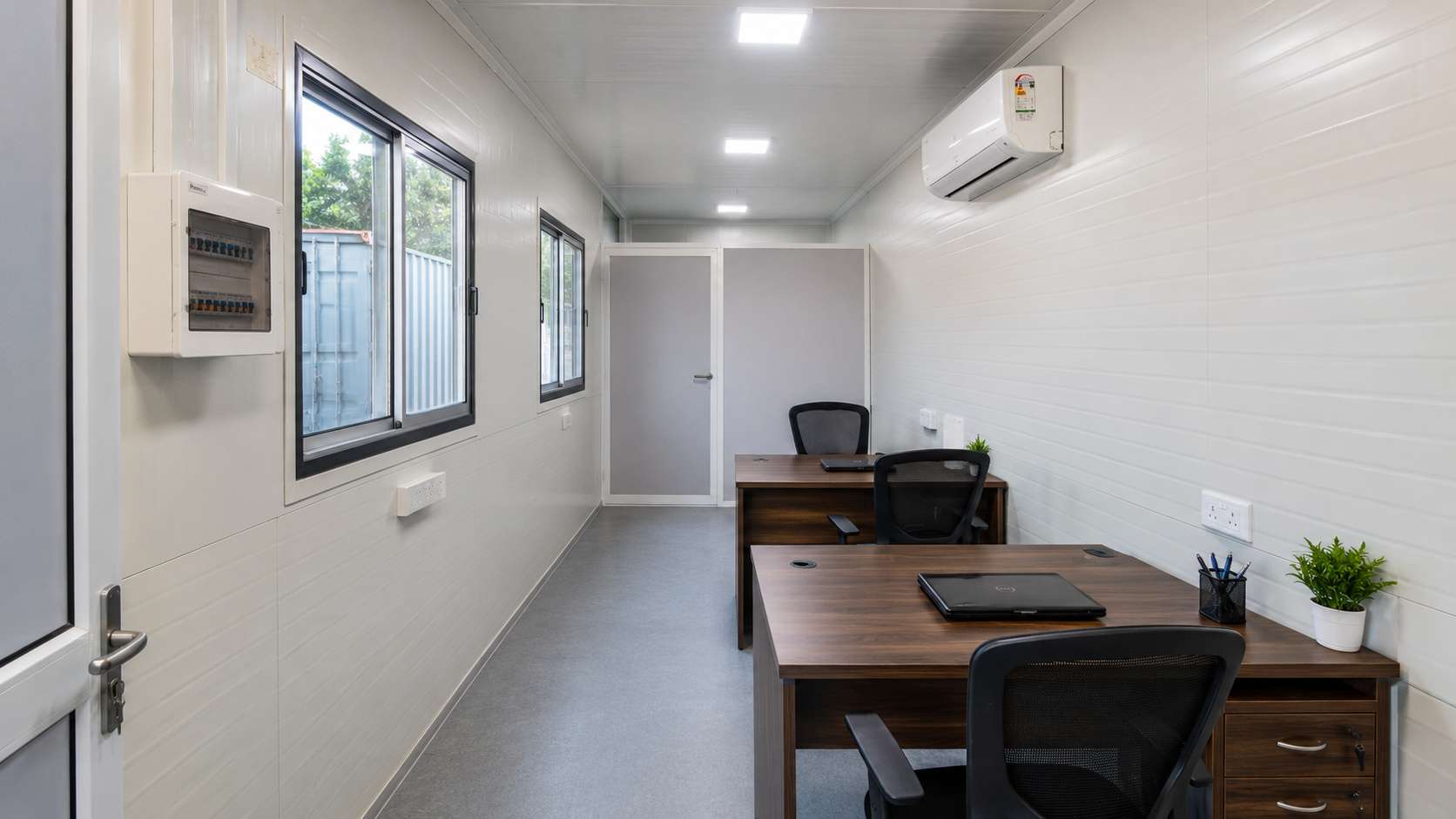 Portable office cabin interior with workstation, MD cabin partition, split AC, and LED panel lights.