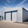 Steel-grey portable shed with black roller doors on a paved yard, 40×30 ft relocatable unit