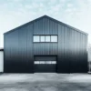 Anthracite grey pre-engineered building structure with gable steel frame, clerestory windows and roller shutter entry.