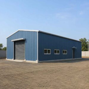 Steel-blue pre-engineered building supplied and erected on a cleared industrial plot, single-storey